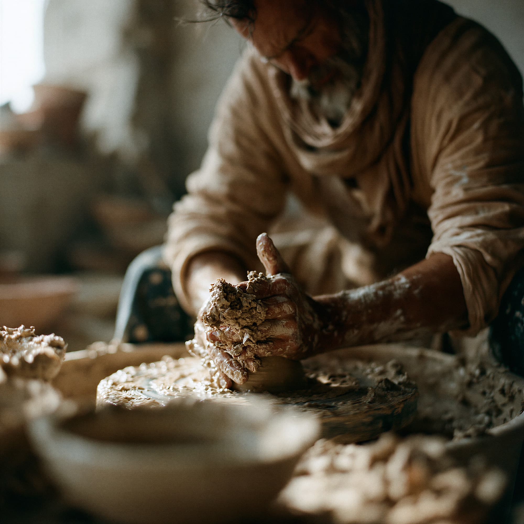 Close-up of hands shaping wet clay on a pottery wheel in warm natural studio light, simulated lifestyle photography created with Midjourney, stamped with VISID structured metadata